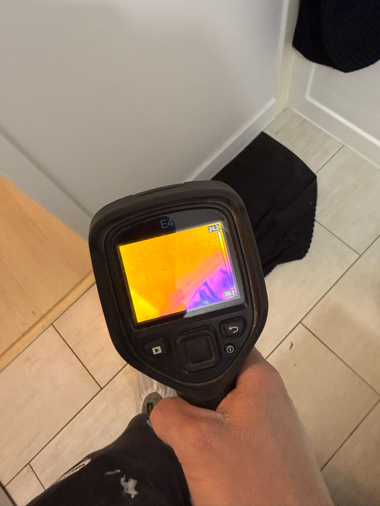 FLIR thermal imaging camera detecting hidden moisture during inspection